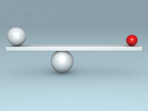 Balance concept with two red and white balls on scales